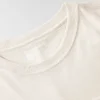 T-shirt feminina de manguitos longos com gola redonda e bolso, em Tencel
